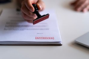 Business Man Stamping With Approved Stamp On Document. Business Man Stamping With Approved Stamp On Document.