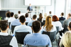 Rear view of business seminar in a board room. Rear view of business seminar in a board room.