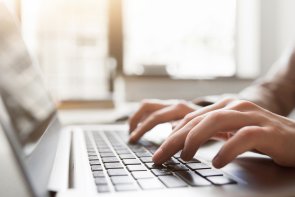 Typing on laptop closeup, chatting in Facebook Typing on laptop closeup, chatting in Facebook